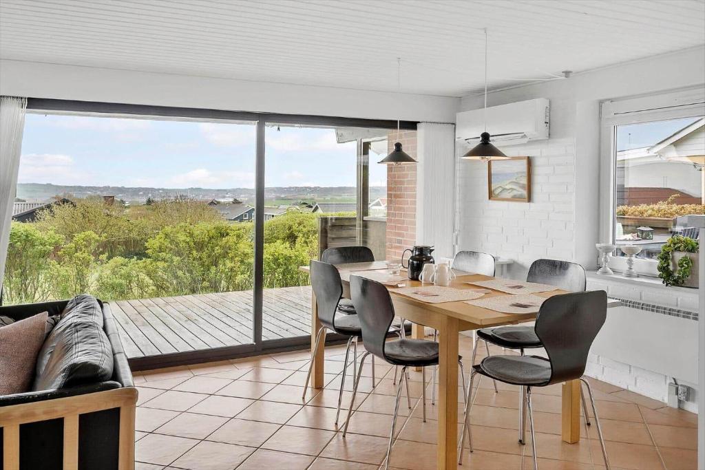 a kitchen and dining room with a table and chairs at G237-Lemvig-Syrenvej-37 in Lemvig