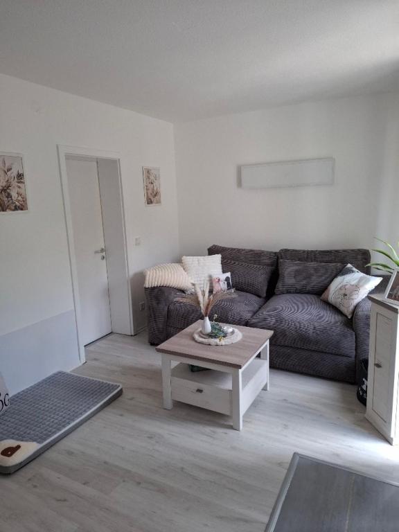 a living room with a couch and a coffee table at De Hecksche Stuuv in Kreuztal