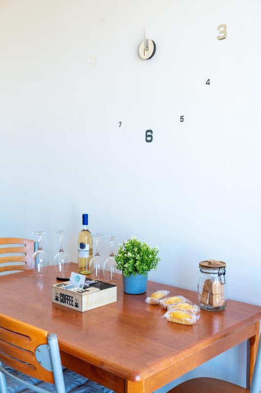a wooden table with bottles of wine on it at Appartamento Clizia in Pescara