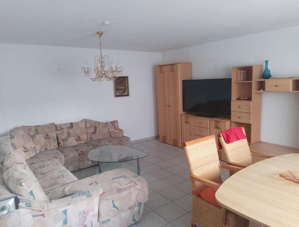 a living room with a couch and a table at Ferienwohnung Brigitte in Volkach