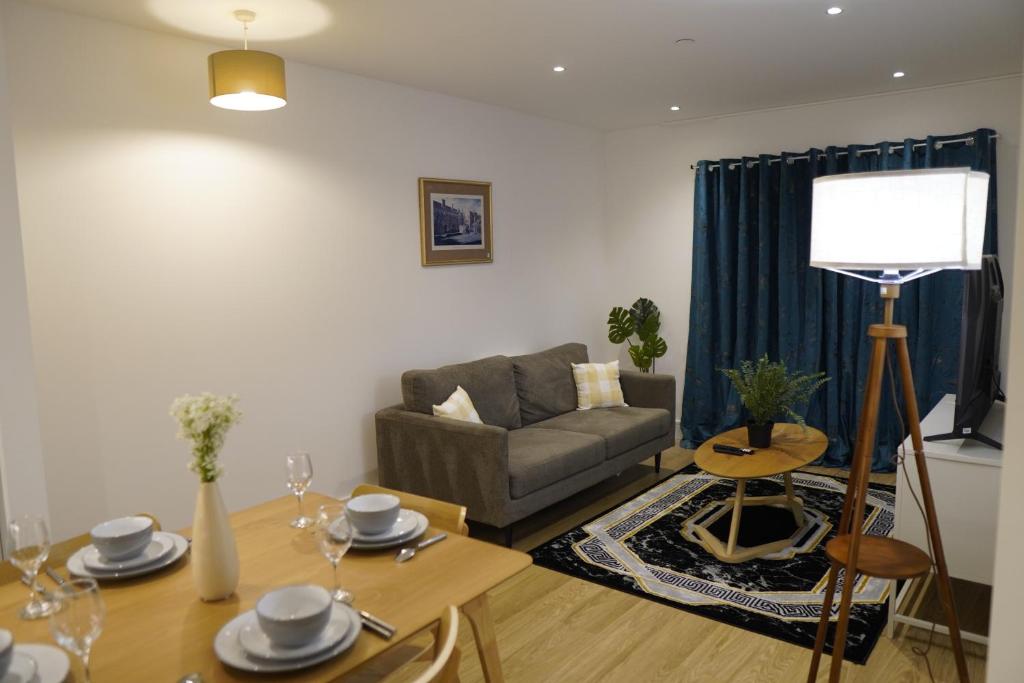 a living room with a couch and a table at Cozy 1 bedroom flat in city centre in Birmingham