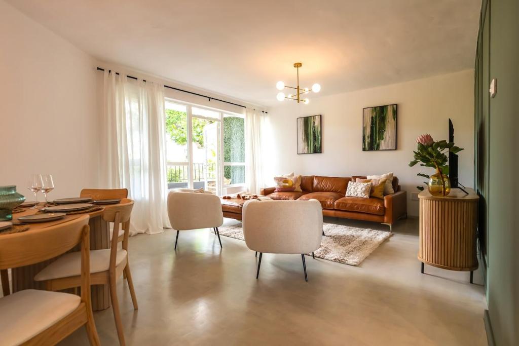 a living room with a couch and a table at Chic apartment with a beautiful view in Cape Town