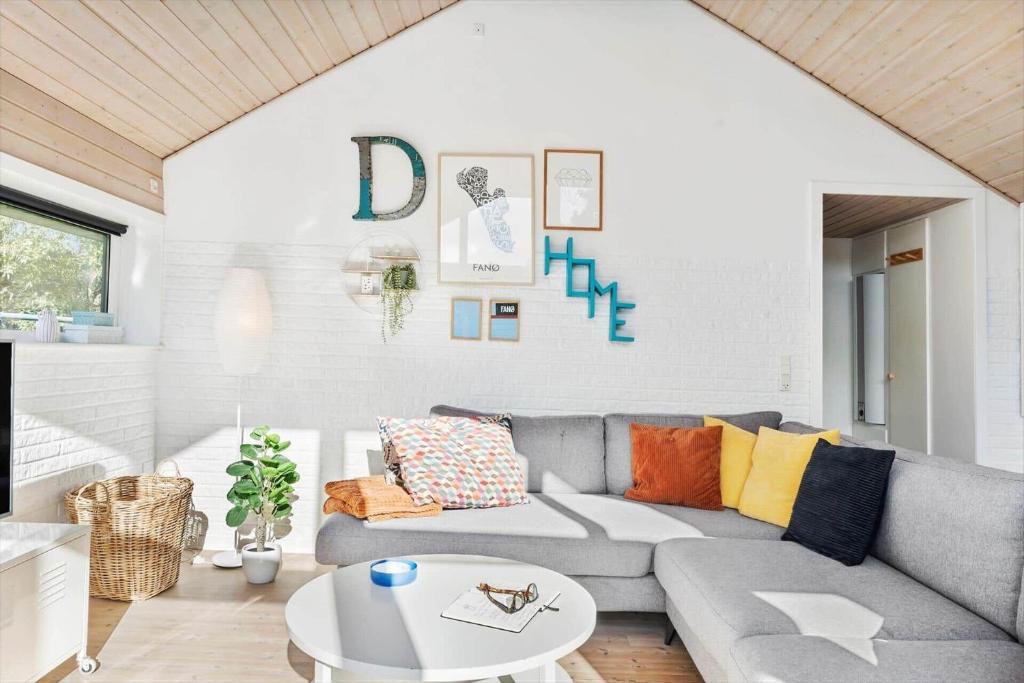 a living room with a couch and a table at FAN007-Fano-Blommens-Toft-5 in Fanø