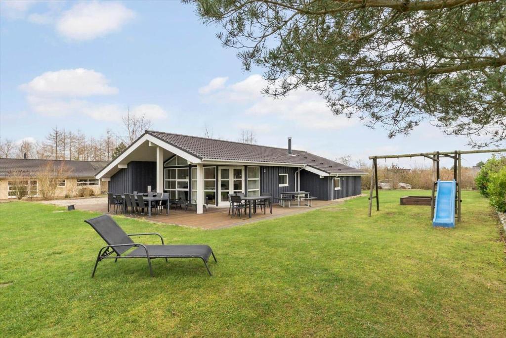 a building with tables and chairs in a yard at 8848-Glesborg-Floden-4 in Glesborg