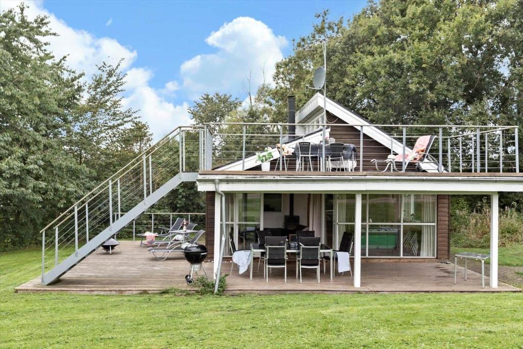 a house with a large deck with a balcony at 84218-Ebeltoft-Koravej-21 in Ebeltoft