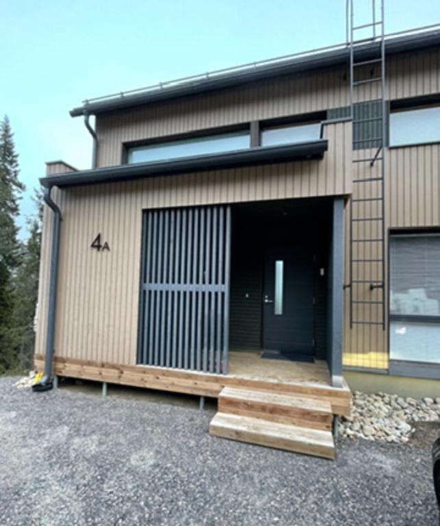 a house with a door and a ramp leading to it at Aamunkoi Skyview Villas A in Syöte