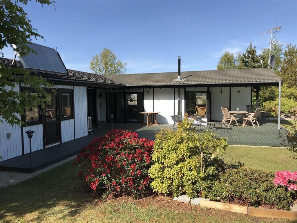 a house with a patio and flowers in the yard at 1158-N-Liseleje-Rugskellet-9 in Liseleje