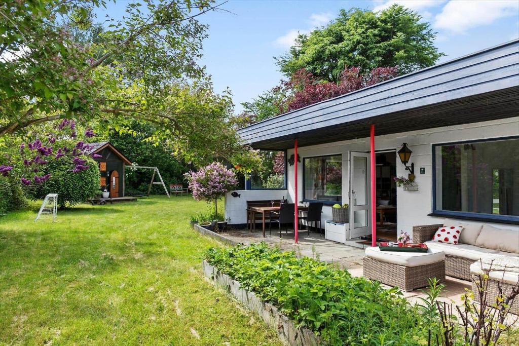 a house with a patio and a yard at 1648-Gilleleje-Dyrholmen-39 in Gilleleje