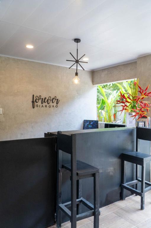 a bar in a restaurant with two black stools at FOREVER SIARGAO in General Luna