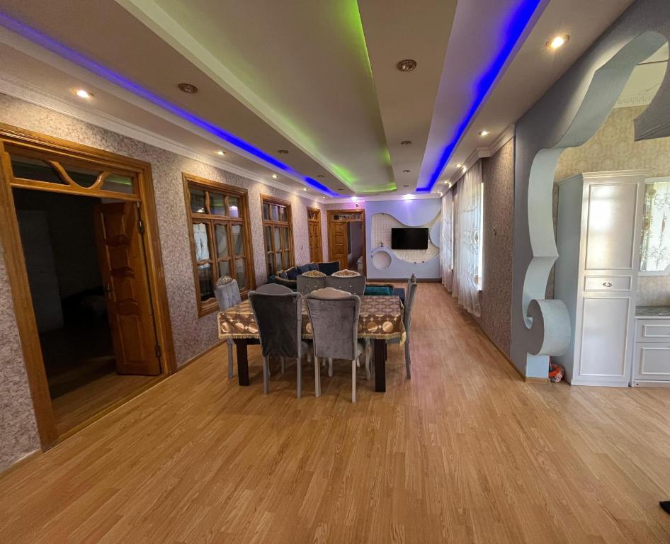 a dining room with a table and a couch at Home in Gabala