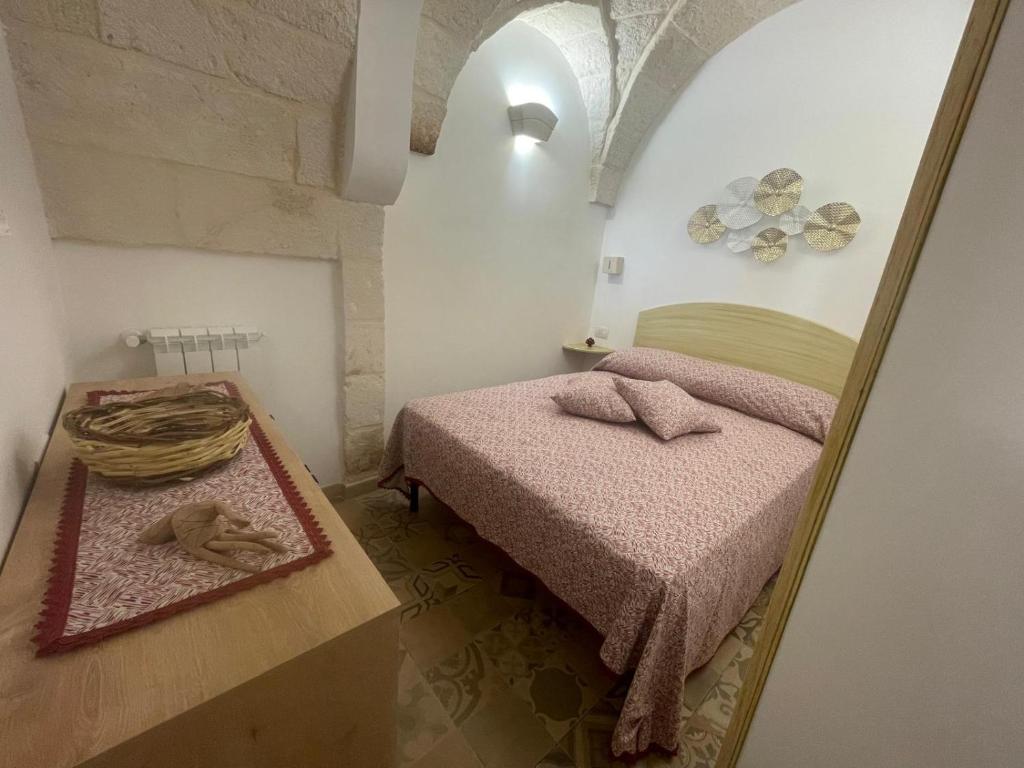 a small bedroom with a bed and a mirror at House Aurora in Fasano