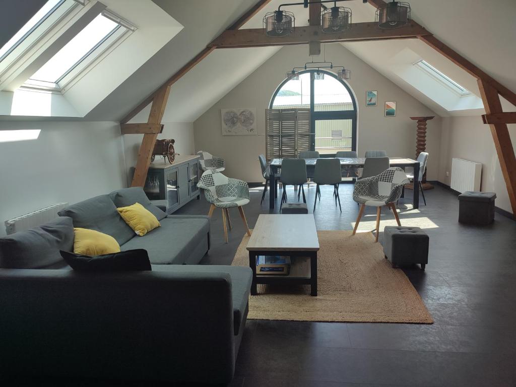 a living room with a couch and a table at La Voilerie in Fécamp
