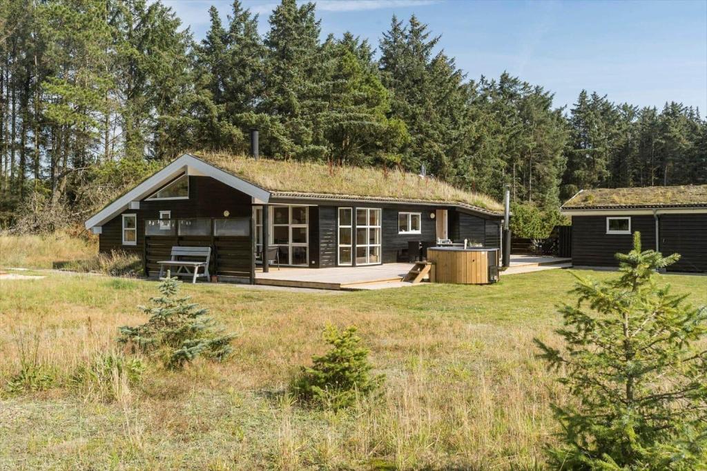 a small black cabin with a grass roof at BL1399-Saltum-Laustvej-30 in Saltum
