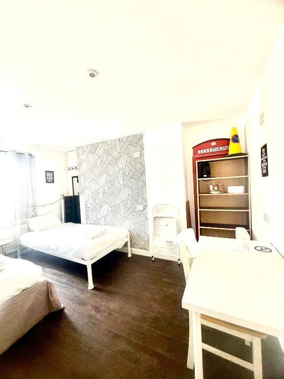 a room with two beds and a stove in it at Hangover Hotel - Seafront 8 in Brighton & Hove