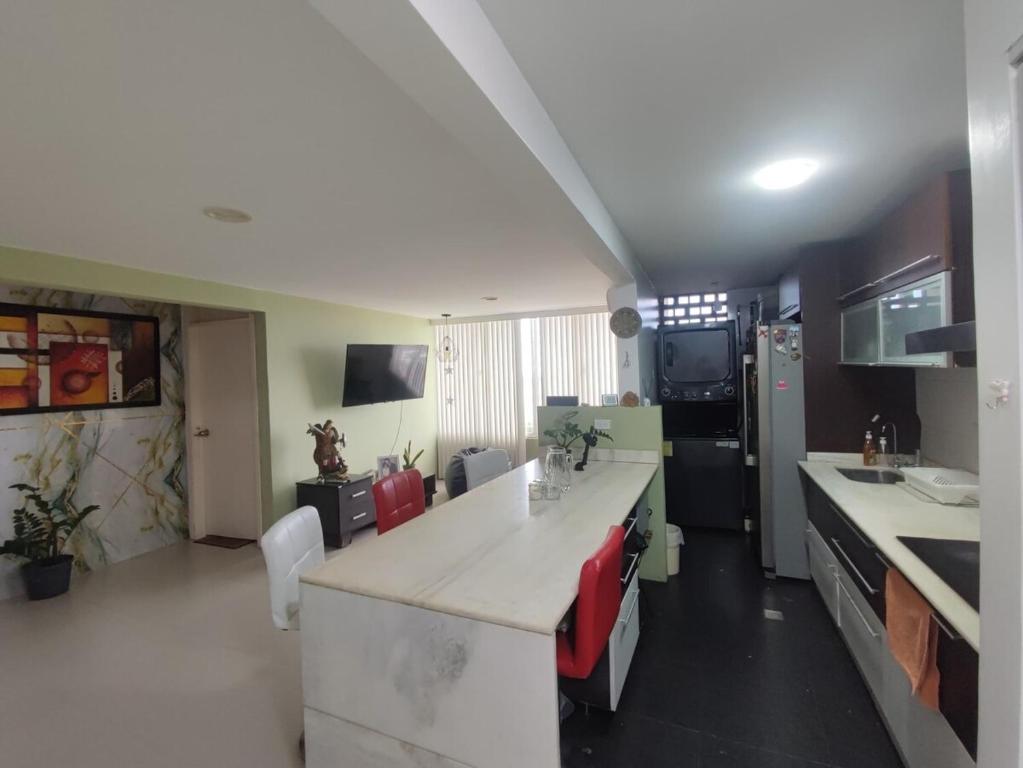 a kitchen with a white counter top in a room at Habitación en apartamento compartido frente a Maiquetía! in Maiquetía