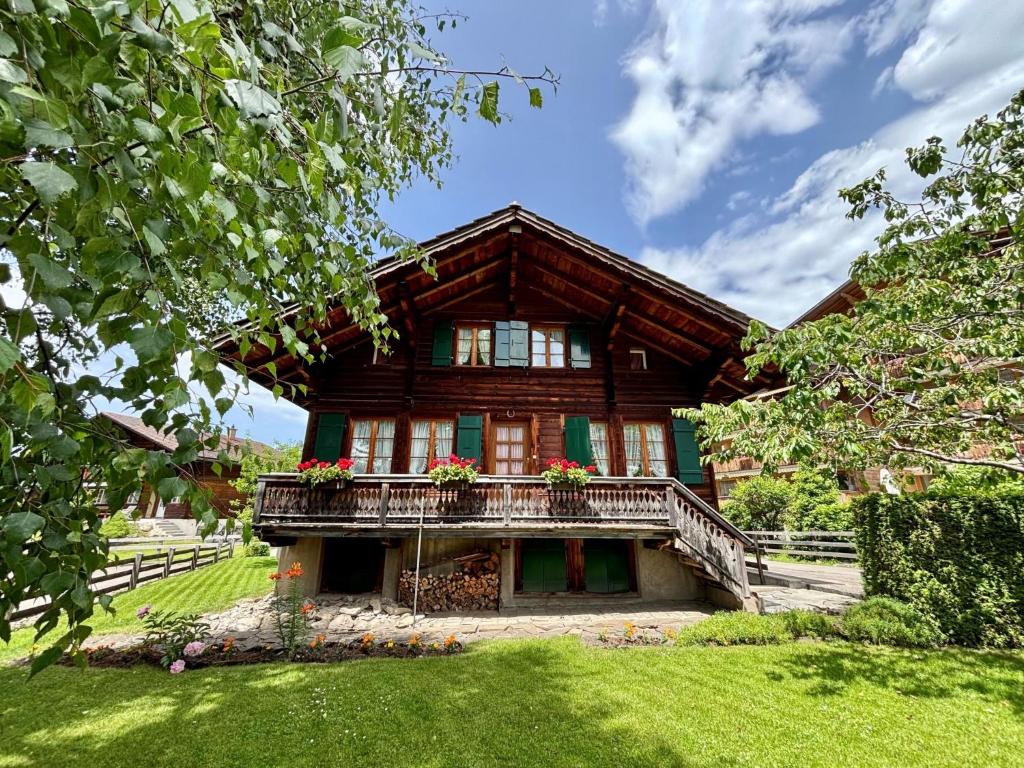 a house with a balcony on the front of it at Chalet Lena - Managed by Hotel Gstaaderhof in Gstaad