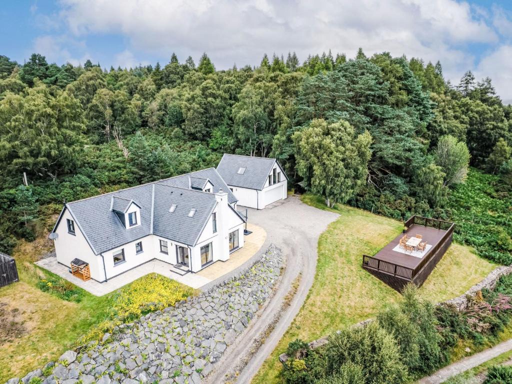 an aerial view of a white house with a gravel driveway at Villa Drover's Lodge by Interhome in Drumnadrochit