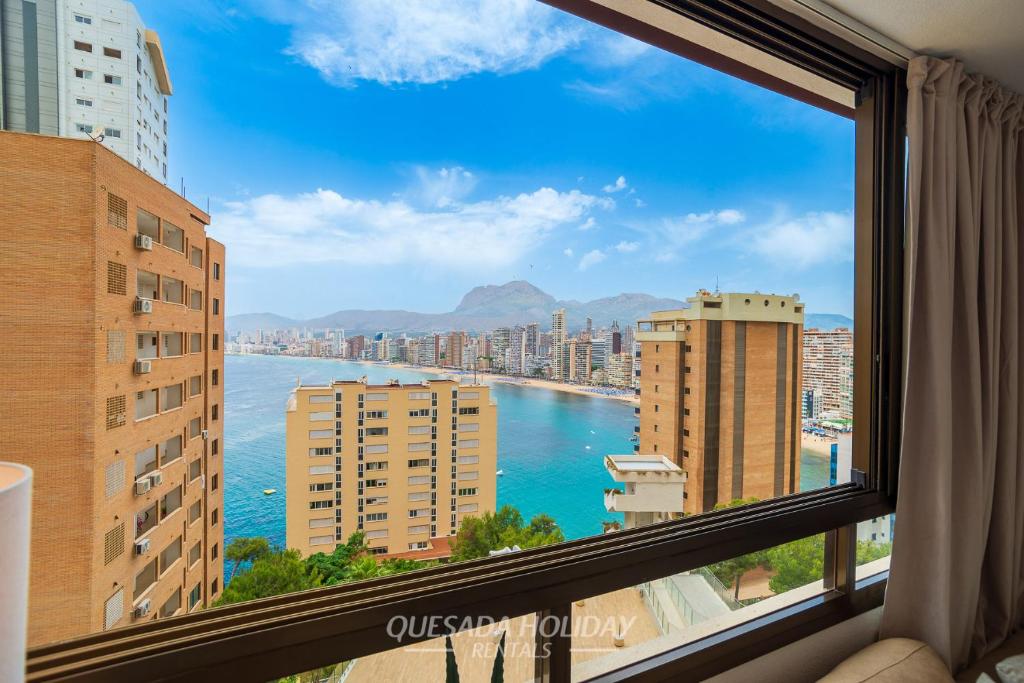 a view of the water from a window in a city at Oasis Levante Beach Benidorm - Trinisol II in Benidorm