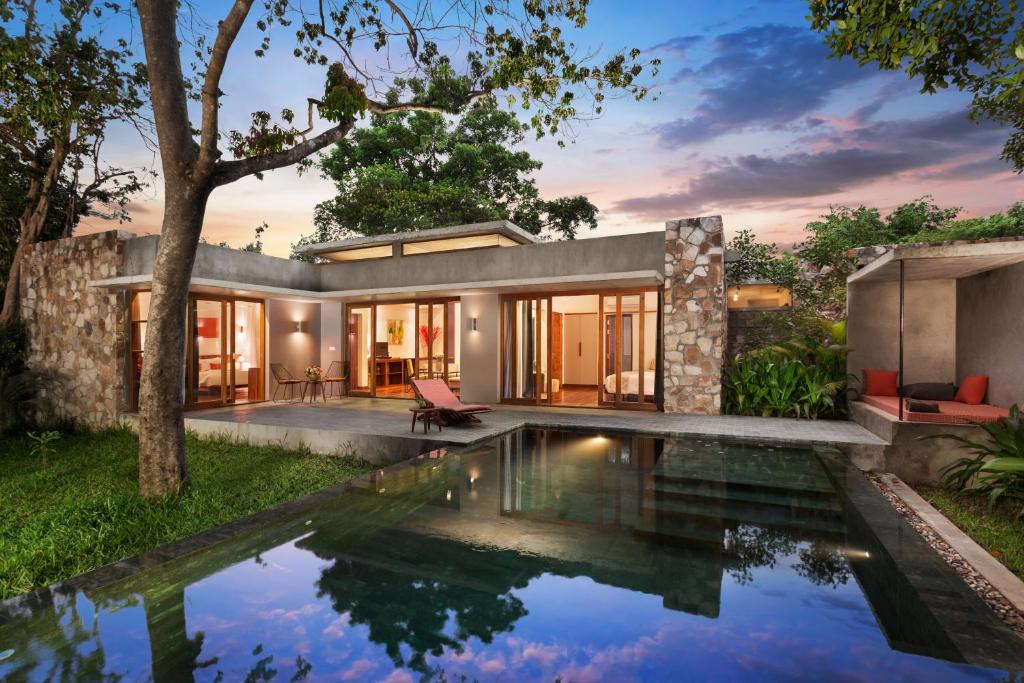 an exterior view of a house with a swimming pool at Templation Hotel in Siem Reap