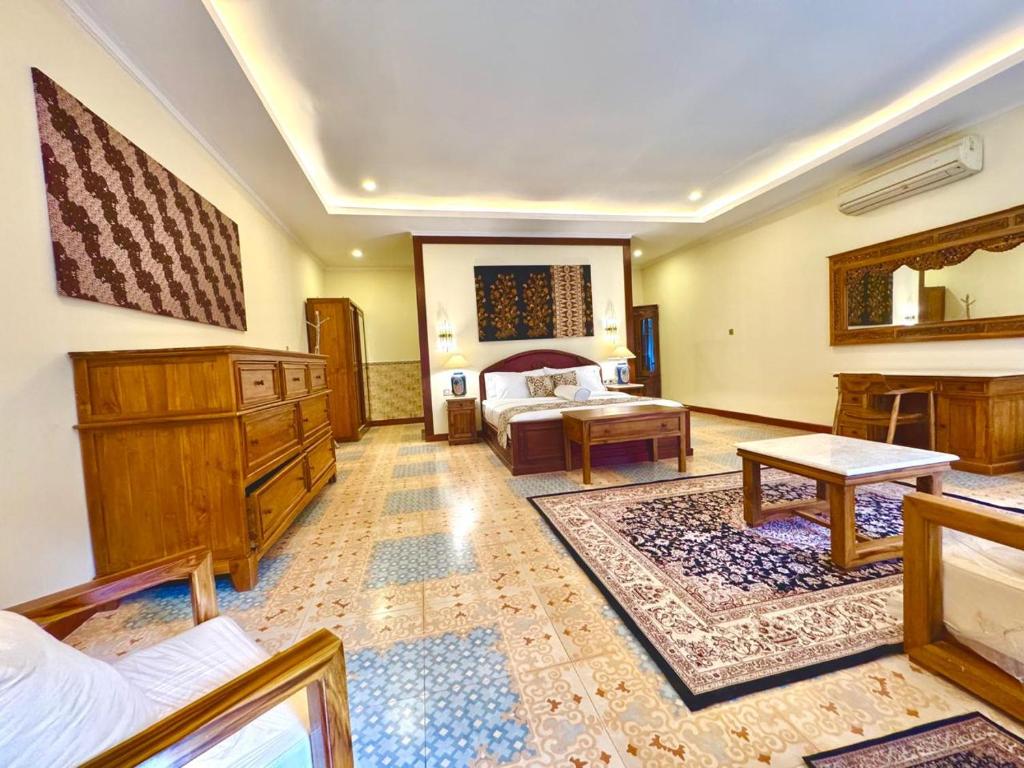 Postel nebo postele na pokoji v ubytování Guci Mas Ghouse
