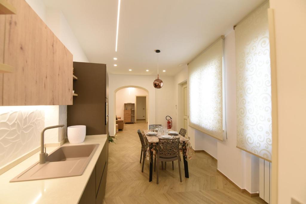 a kitchen and dining room with a table and chairs at La casa di Nonna Afra in Agerola