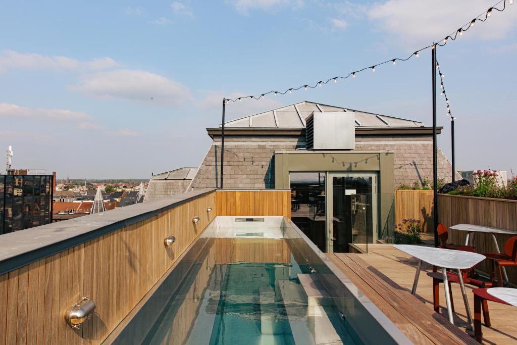 a swimming pool on the roof of a building at JAM Ghent in Ghent