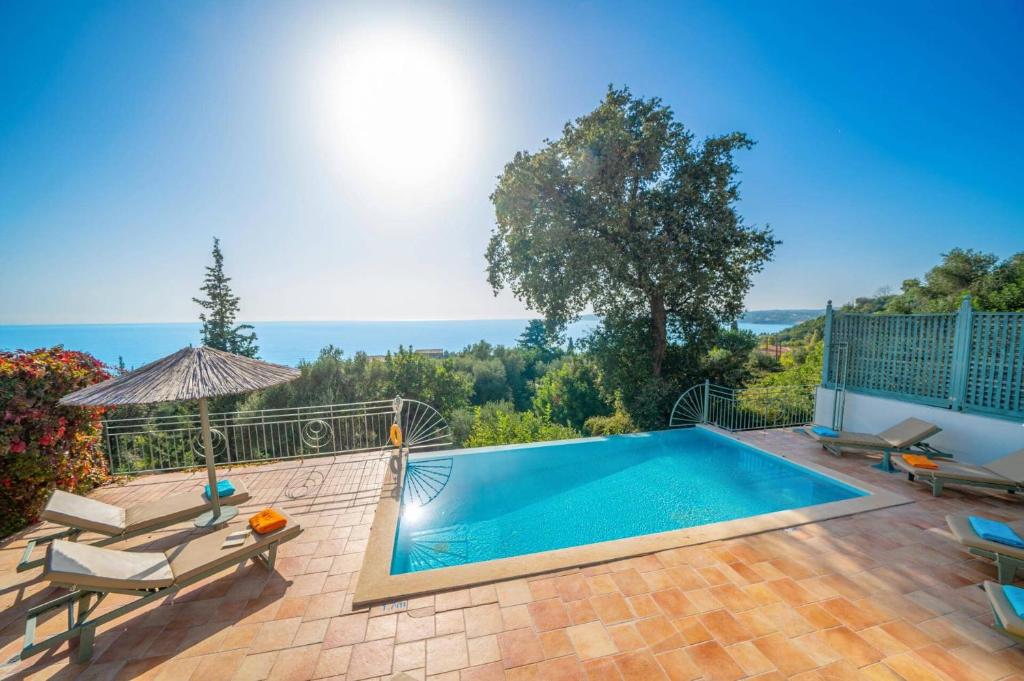 a swimming pool in a yard with chairs at Villa Leanda by Villa Plus in Lourdhata