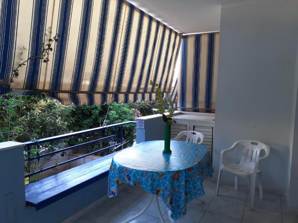 a balcony with a table with a vase on it at PM 108 Viale Europa in Alghero