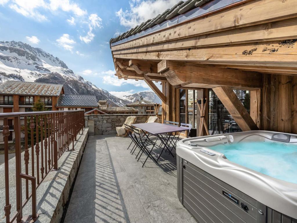a hot tub on the balcony of a house at Appartement Duplex avec Terrasse, Jacuzzi et Cheminée - Val-d'Isère - FR-1-567-63 in Val dʼIsère