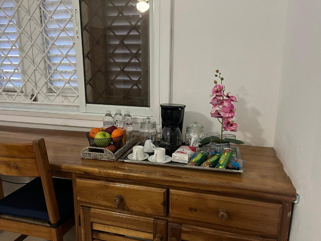 a wooden table with a tray of fruits and vegetables on it at villa chiara in Las Terrenas