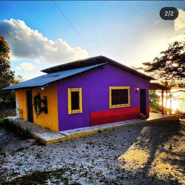 a small house with a purple and yellow at Casa Josuá in Nísia Floresta
