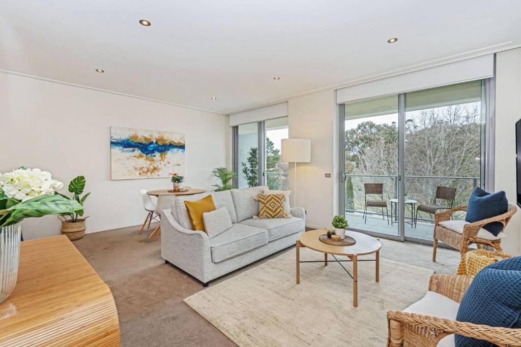 a living room with a couch and a table at Glebe Park Cityside with Style in Canberra