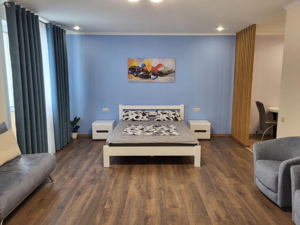 a living room with a bed and a couch at ObolonSky apartament on Obolon in Kyiv