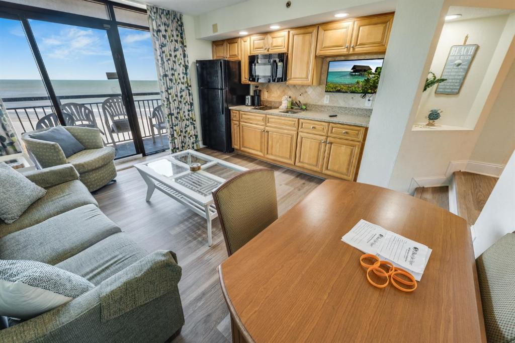 a living room with a couch and a table at Low Floor 1BR, Direct Oceanfront Beautiful, Pools! in Myrtle Beach