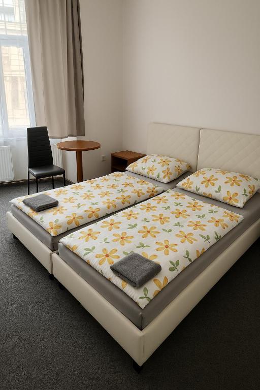 a bedroom with a bed and a chair at Rooms v samém centru Ostravy in Ostrava