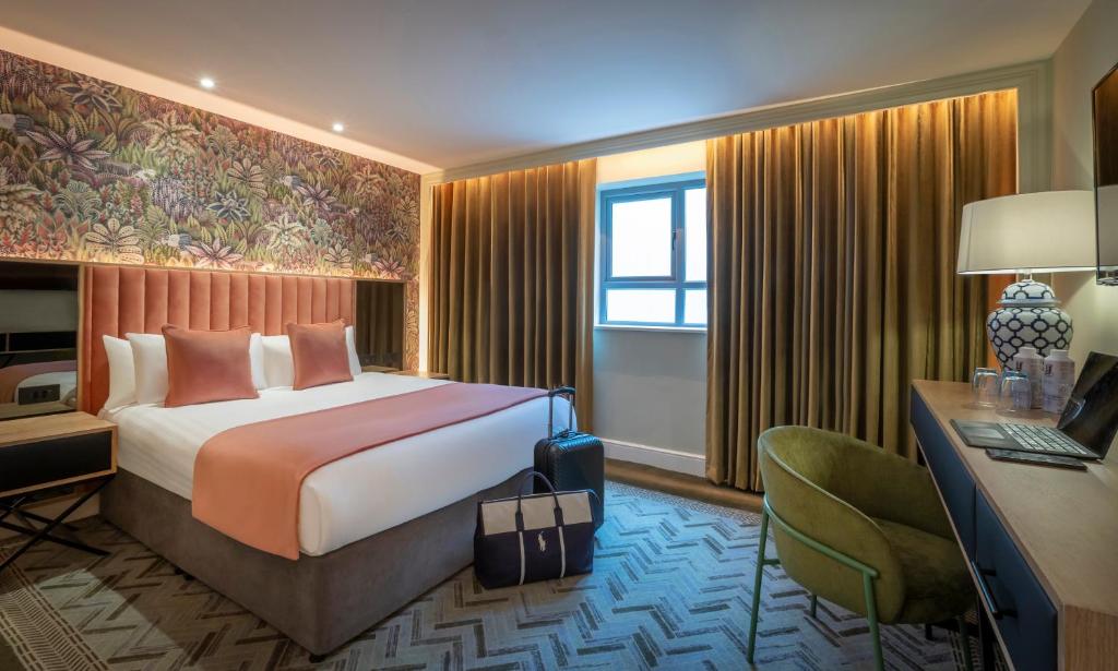 a hotel room with a bed and a desk and a computer at HYDE Hotel in Galway