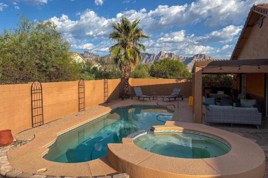 a swimming pool with a fence and a palm tree at 4 Mi to Catalina State Park Mountain-View Home in Oro Valley