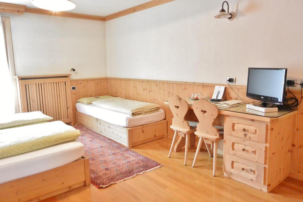 Postel nebo postele na pokoji v ubytování Hotel Garnì al Plan