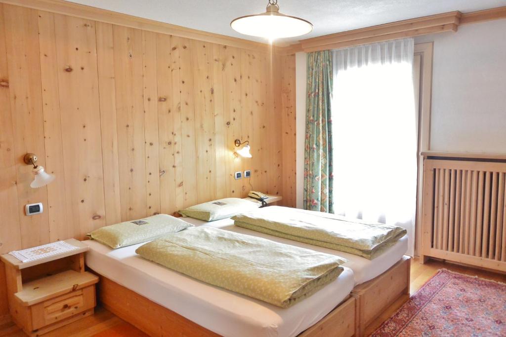 Postel nebo postele na pokoji v ubytování Hotel Garnì al Plan