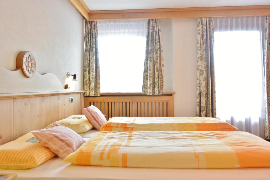 Postel nebo postele na pokoji v ubytování Hotel Garnì al Plan