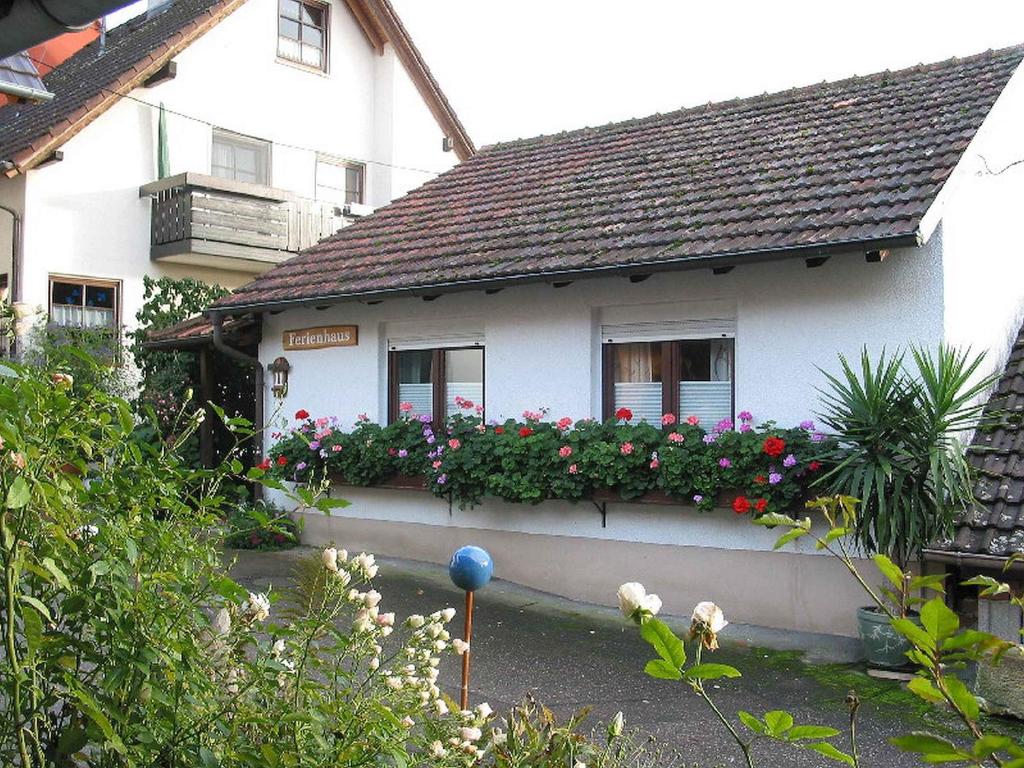 a white house with flowers in front of it at Ferienhaus Steinger am Blumengässle in Müllheim