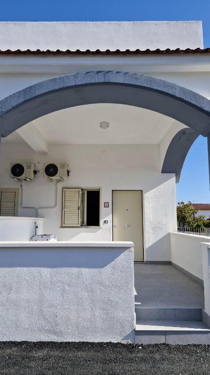 a building with an archway in front of a building at Il cedro blu in Santa Maria del Cedro