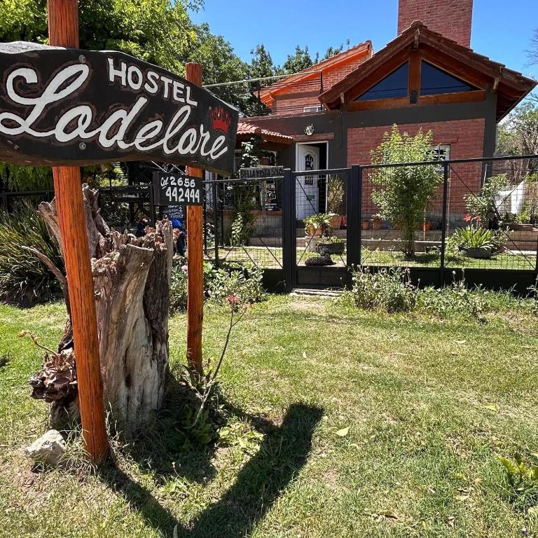 a sign for a hostelel laureate in front of a house at Lodelore in Merlo