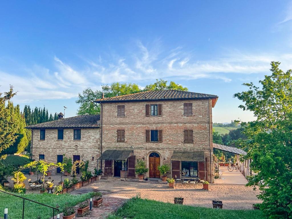 a large brick building with a courtyard in front of it at Villa San Lorenzo - Lux Gated Estate/Private Pool in Gioiella