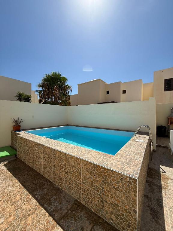 a swimming pool in the backyard of a house at Villa LiLo Private House with Heated Pool in Costa Teguise