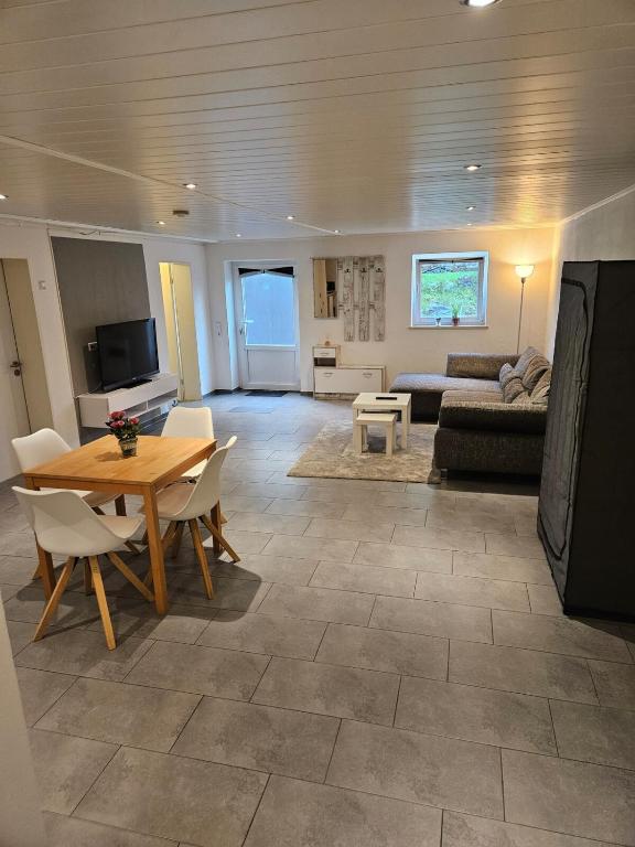 a living room with a table and a couch at 1-Zimmer Apartment in Oberopfingen