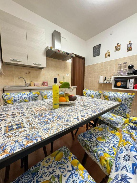 a kitchen with a table with blue and white tiles at Profumo di Sicilia Augusta in Augusta