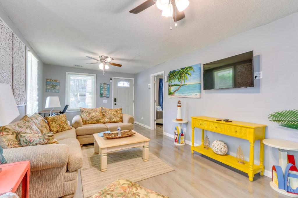 a living room with a couch and a tv at Beachy Home in Heart of Beaufort with Pool Access in Beaufort