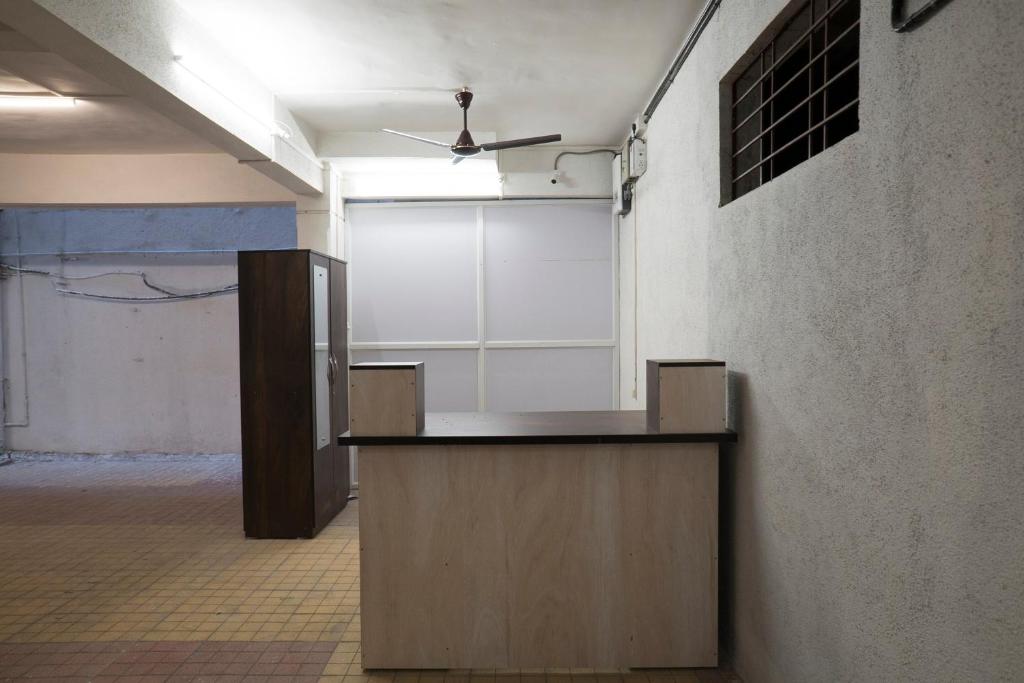 an empty room with a counter in a building at Hotel O RVC Hospitality Near Pune Airport in Kharadi