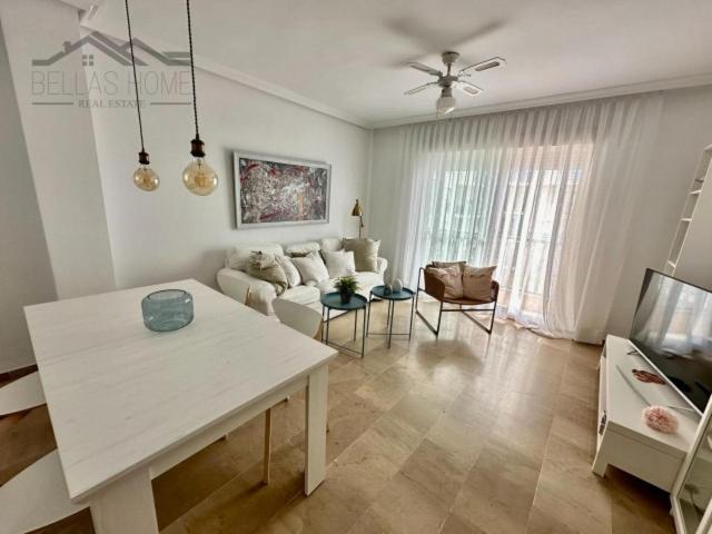 a living room with a couch and a table at Faro Bay in Estepona
